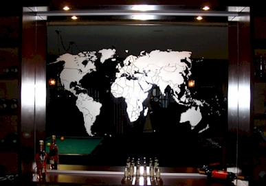 sandblasted image of world map on a mirror / copyright © Vision2form